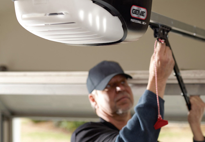 Close-up of professional technician installing a garage door opener